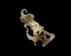 A silver-gilt fibula of Diana the huntress and a leaping deer,Possibly Roman, with signs of...