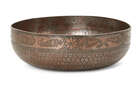 An engraved tinned copper magic bowl,North India, 19th century,
On plain base, densely inscribed...