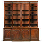 
	
		A George III mahogany breakfront bookcase, late 18th century, the fluted cornice above...