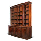 
	
		A George III mahogany breakfront bookcase, late 18th century, the fluted cornice above...