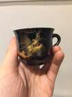 
	
		A Chinese painted lacquer coffee set, 20th century, comprised of eight cups and saucers...