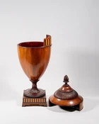 A George III mahogany urn shape knife box, with ebony and fruitwood stringing and inlaid frieze...