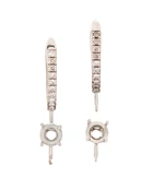 A pair of 18ct white gold diamond set earring mounts with vacant collets, designed as a...