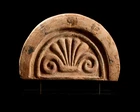 An Etruscan terracotta antefix,circa 6th Century B.C.,
the central palmette within an arched...