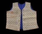 A small embroidered waist coat,India, 
yellow metal thread medallions against black, lined in...