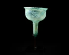 A Byzantine pale blue glass stemmed lamp insertcirca 6th Century A.D.,
With stand,
10.5cm...