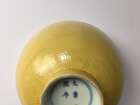 
	
		A Chinese porcelain incised yellow-glazed bowl, Kangxi mark and of the period, incised to...