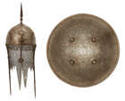 
	
		A Qajar gold damascened steel helmet and shield,
		Persia, 19th century, the helmet of...