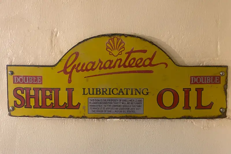 An Early 'Guaranteed Shell Lubricating Oil' Enamel Sign-Sold