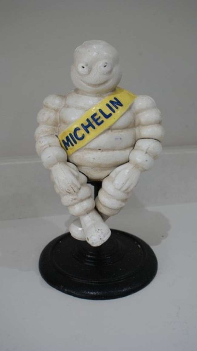 'Michelin Man on stool' figure.-Sold