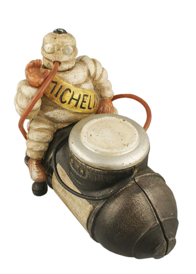 'Michelin Man on Compressor'. Cast iron figure.-Sold