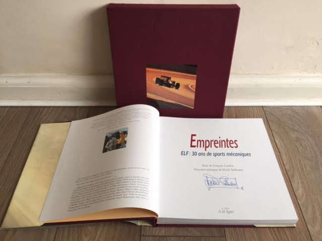 Sir Jackie Stewart signed Elf Commemorative book.-Sold