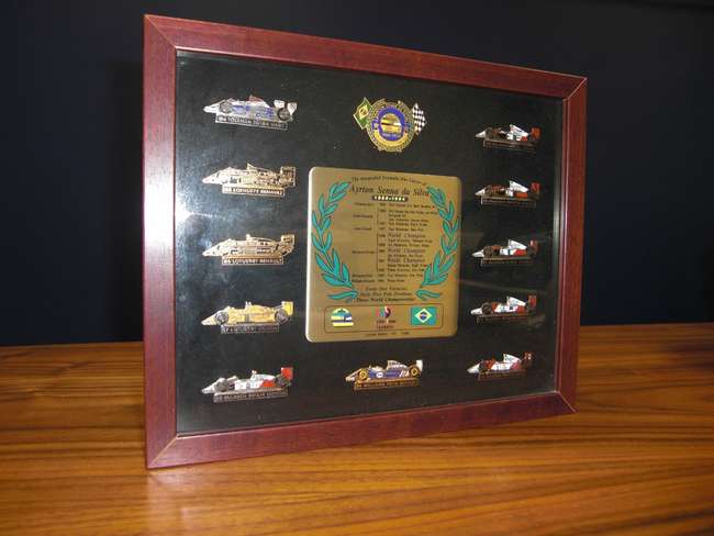 Framed collection of Ayrton Senna lapel career badges -Sold
