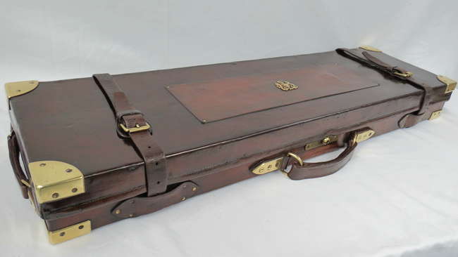 An oak and leather bound 12G gun case with brass corners-Sold