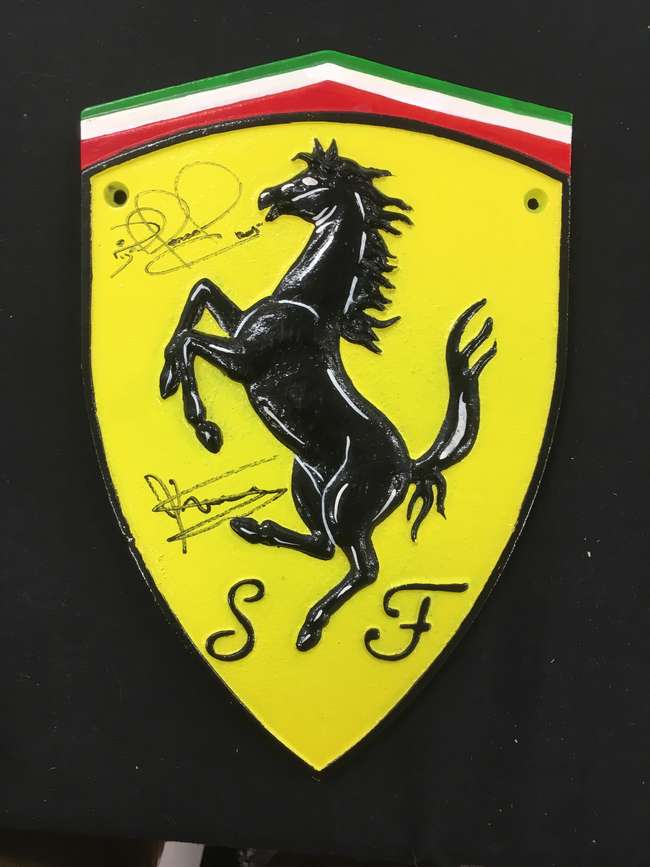 Ferrari metal shield, signedNigel Mansell CBE and Scheckter-Sold