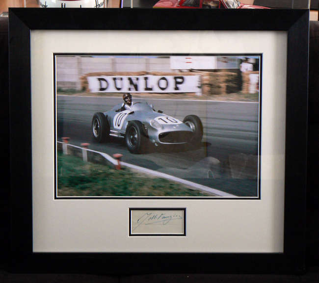 Juan Manuel Fangio, signed, framed colour print.	-Sold