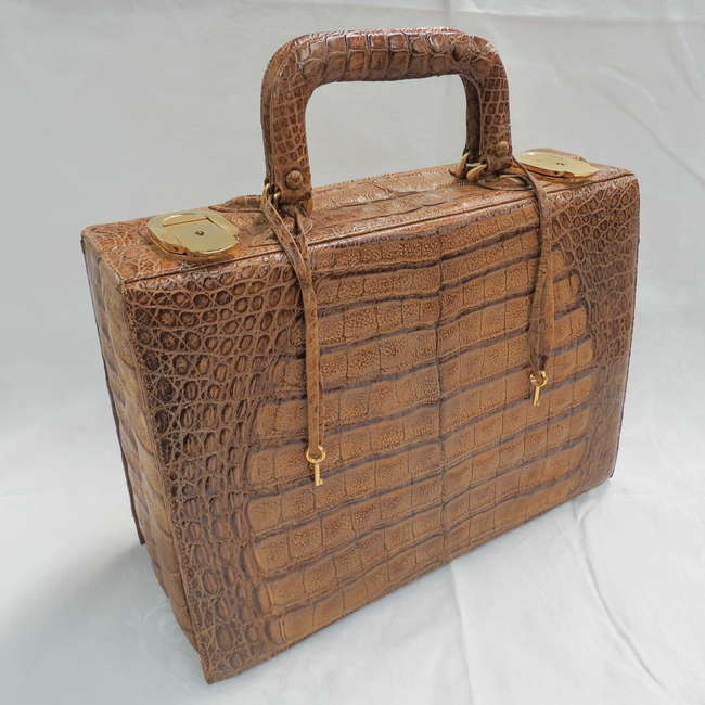 A crocodile skin 'weekend case' or 'vanity case'-Sold
