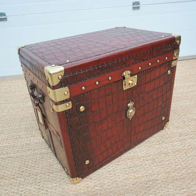 A crocodile skin and leather bound travel trunk -Sold