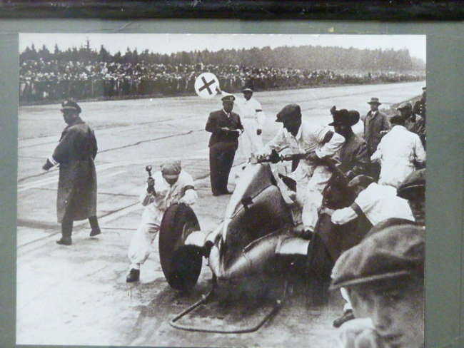 A selection of Motor Racing Paintings and Photos.-Sold