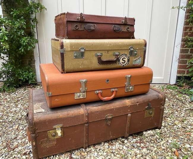 Selection of Four Well-Travelled Suitcases-Auction Lot