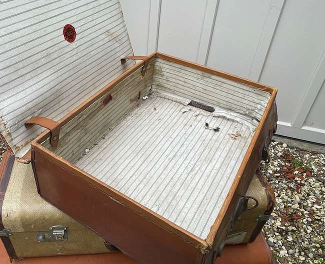 Selection of Four Well-Travelled Suitcases-Auction Lot