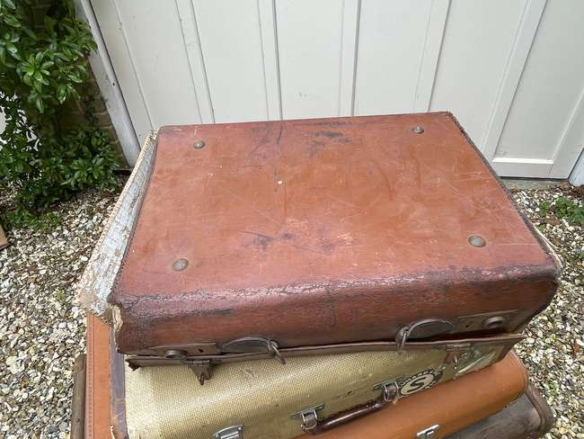 Selection of Four Well-Travelled Suitcases-Auction Lot