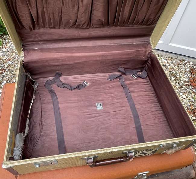 Selection of Four Well-Travelled Suitcases-Auction Lot