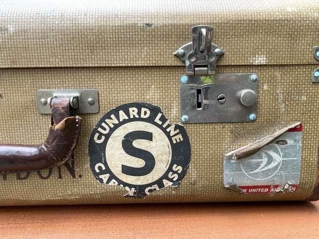 Selection of Four Well-Travelled Suitcases-Auction Lot