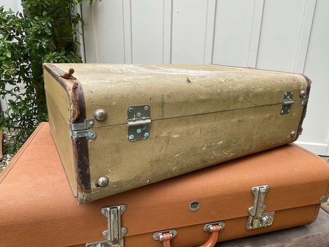 Selection of Four Well-Travelled Suitcases-Auction Lot