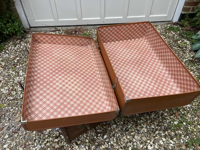Selection of Four Well-Travelled Suitcases-Auction Lot