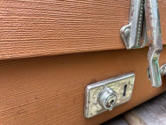 Selection of Four Well-Travelled Suitcases-Auction Lot