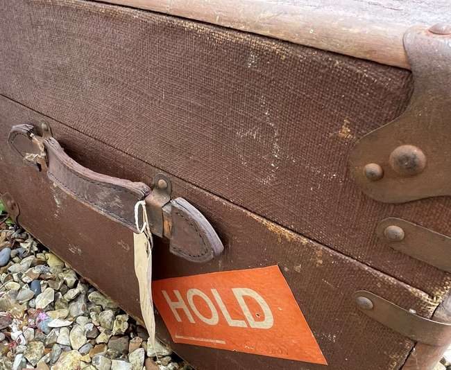 Selection of Four Well-Travelled Suitcases-Auction Lot