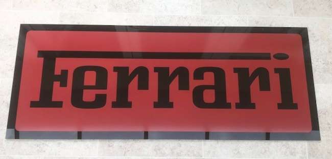 A Ferrari-themed Celluloid Garage-Type Wall Sign-Sold