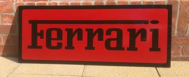 A Ferrari-themed Celluloid Garage-Type Wall Sign-Sold