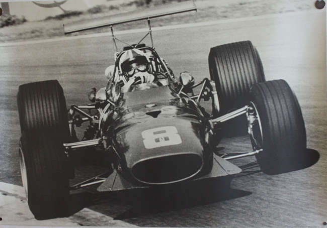 Seven Large Format Photographic Prints of Racing Ferraris Through the Years