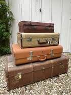 Selection of Four Well-Travelled Suitcases-Auction Lot