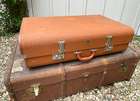 Selection of Four Well-Travelled Suitcases-Auction Lot