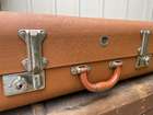 Selection of Four Well-Travelled Suitcases-Auction Lot