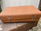 Selection of Four Well-Travelled Suitcases-Auction Lot