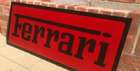 A Ferrari-themed Celluloid Garage-Type Wall Sign-Sold