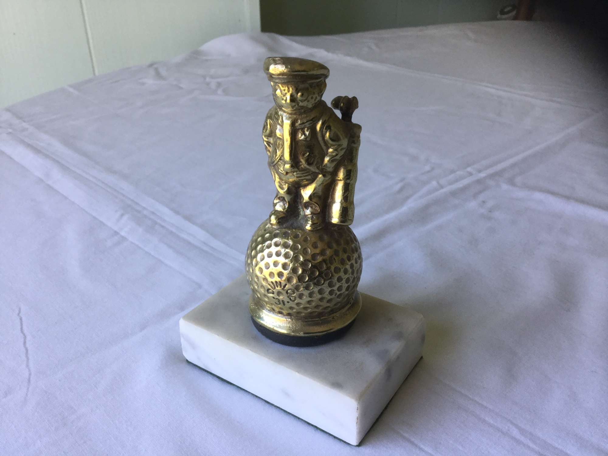 Brass 'Dunlop 31' golfer' mascot on marble base.-Sold