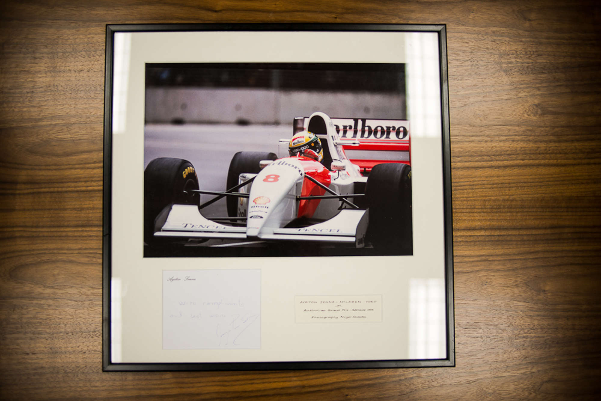 A desirable Signed Ayrton Senna photograph, framed & glazed-Sold
