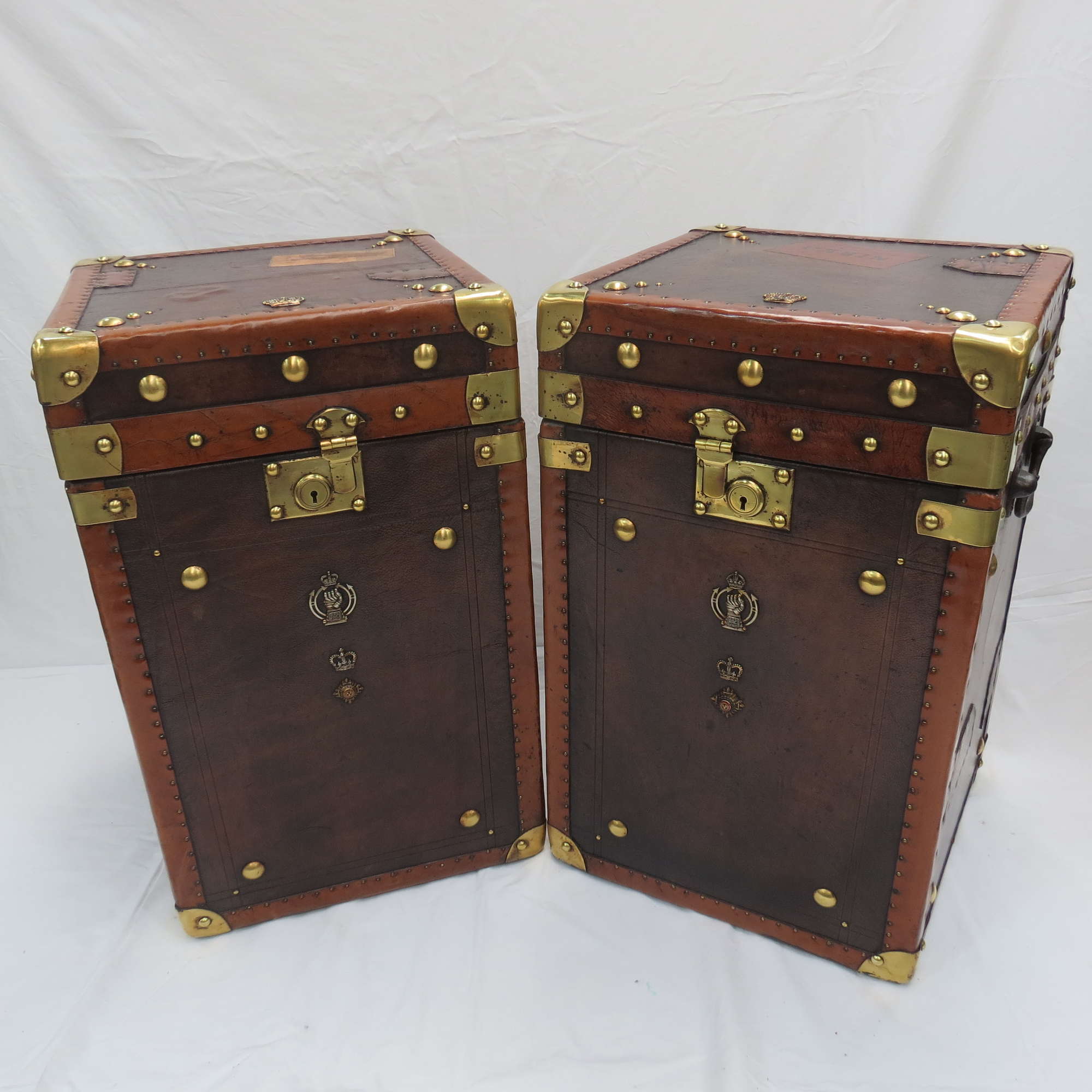 A pair of 'Army and Navy' leather covered Travel Trunks-Sold