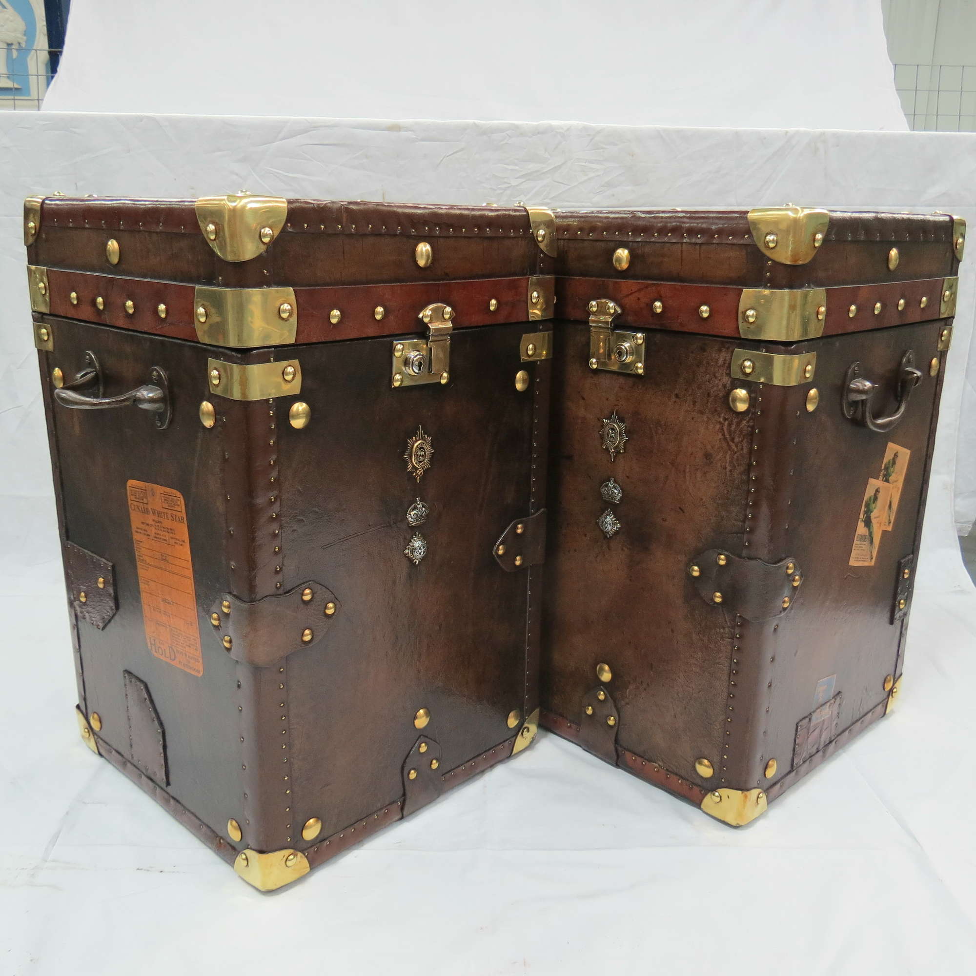 A Pair of Army and Navy Leather covered Trunks-Sold