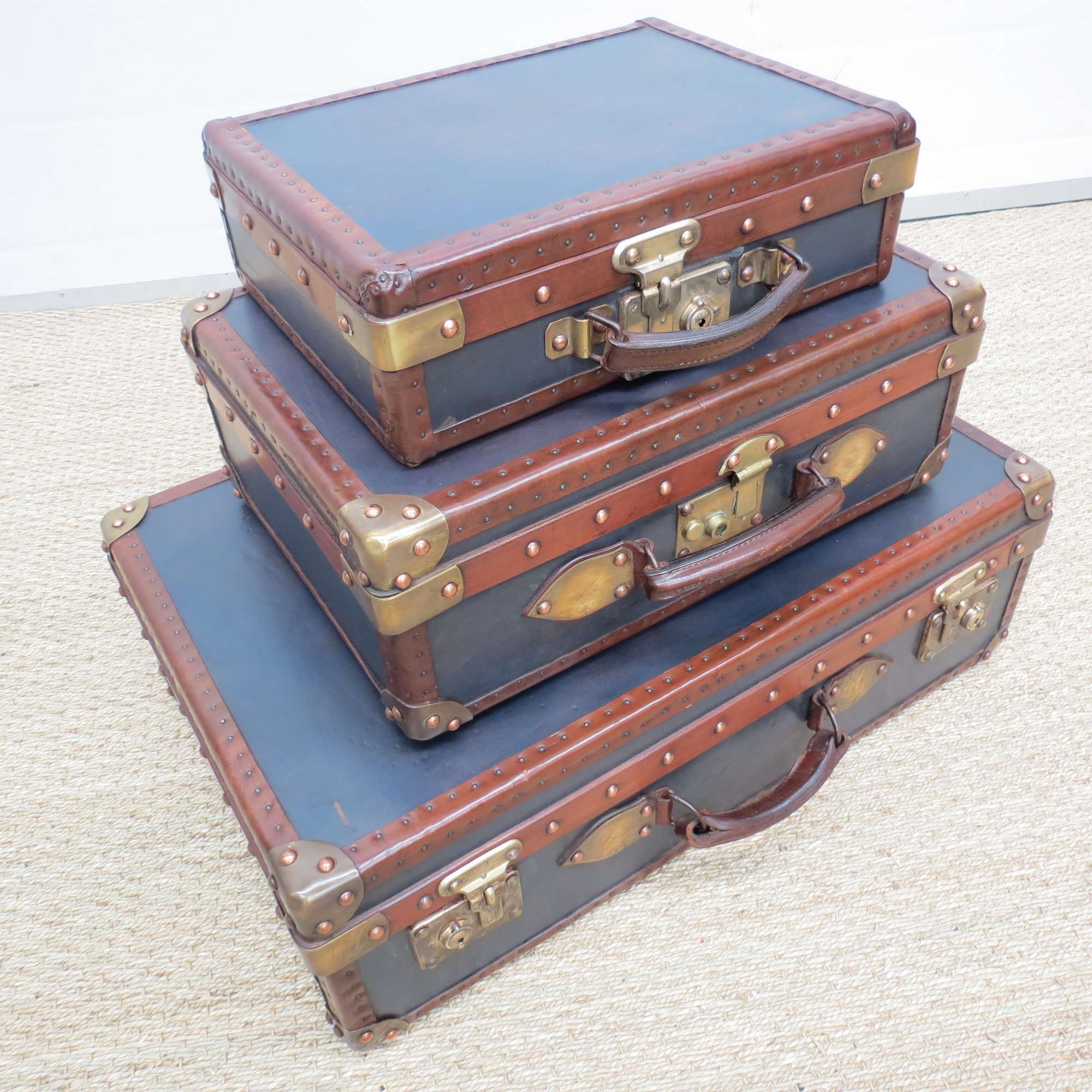 A set of three blue leather suitcases-Sold