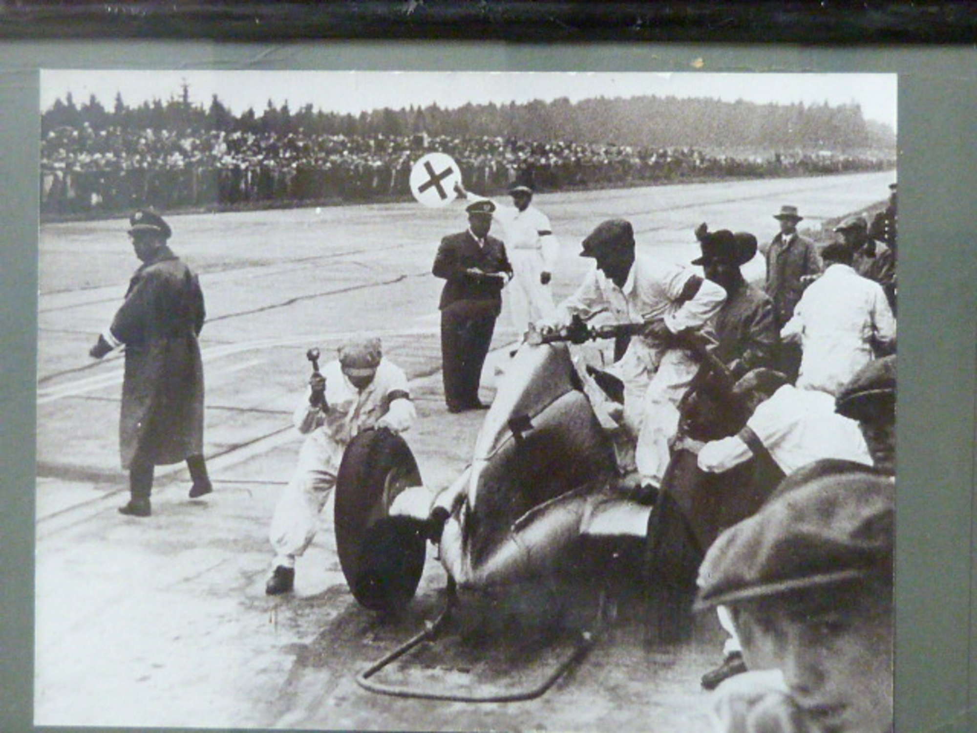 A selection of Motor Racing Paintings and Photos.-Sold