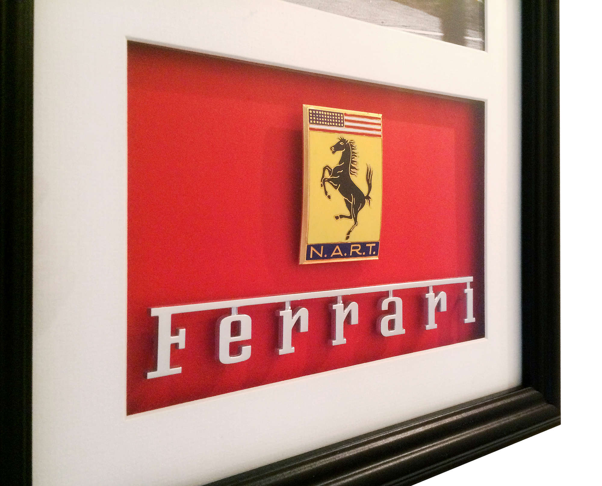 Iconic Auctioneers | Framed Ferrari N.A.R.T. enamel car badge -Sold