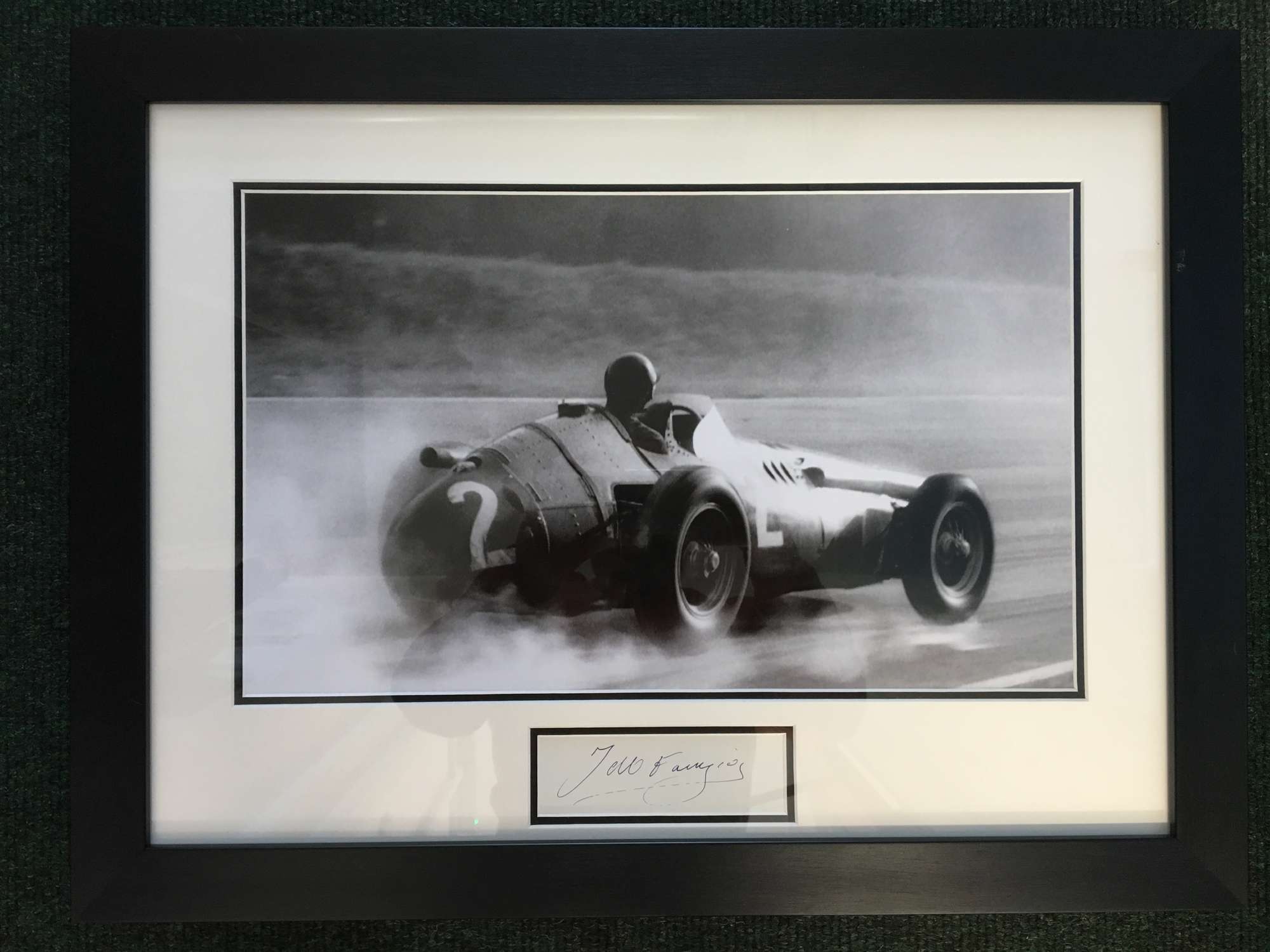 J M Fangio, Maserati 250F in the wet framed photo-Auction Lot