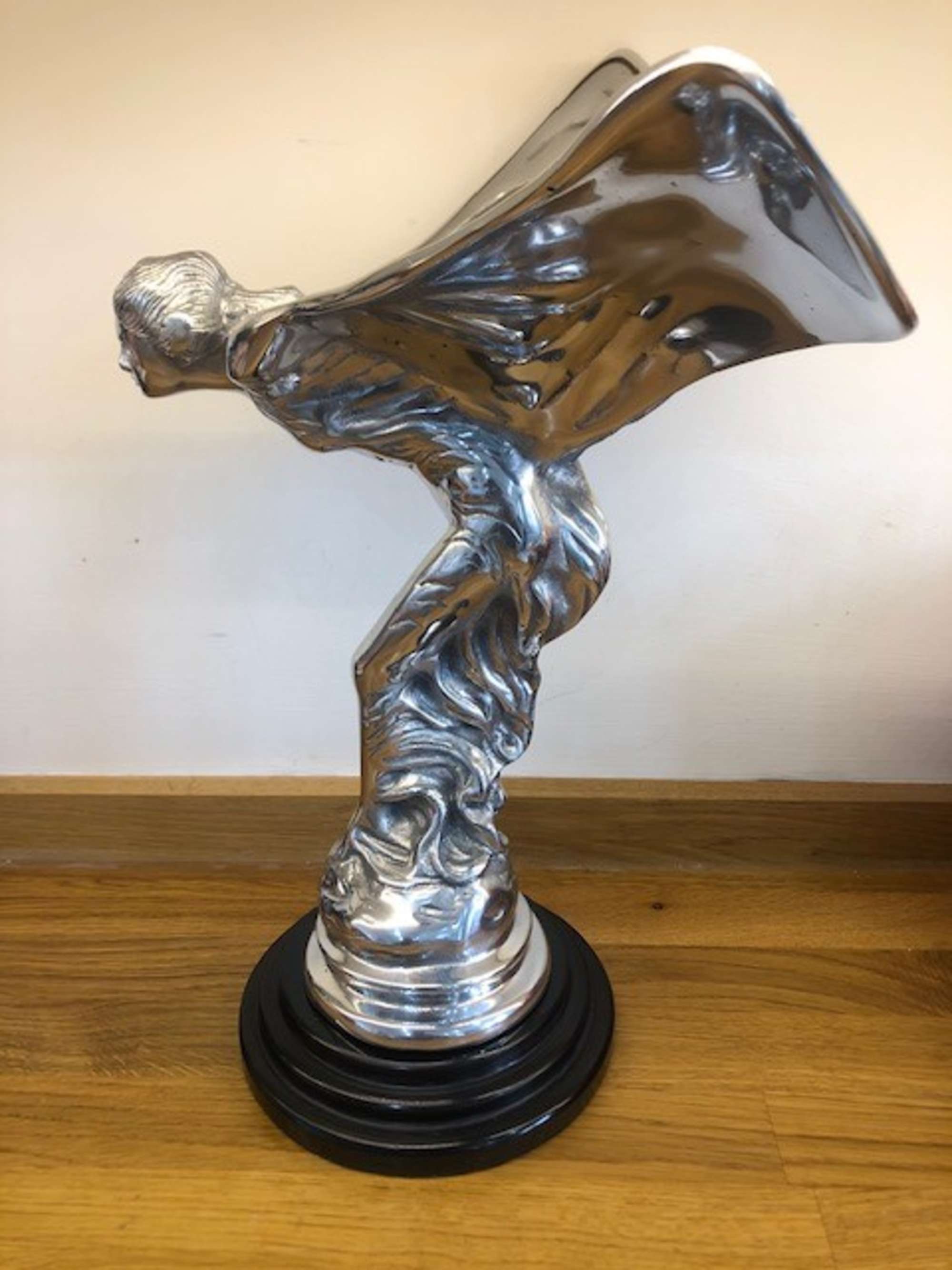 An over-sized cast metal and silvered statue of the Spirit o-Sold