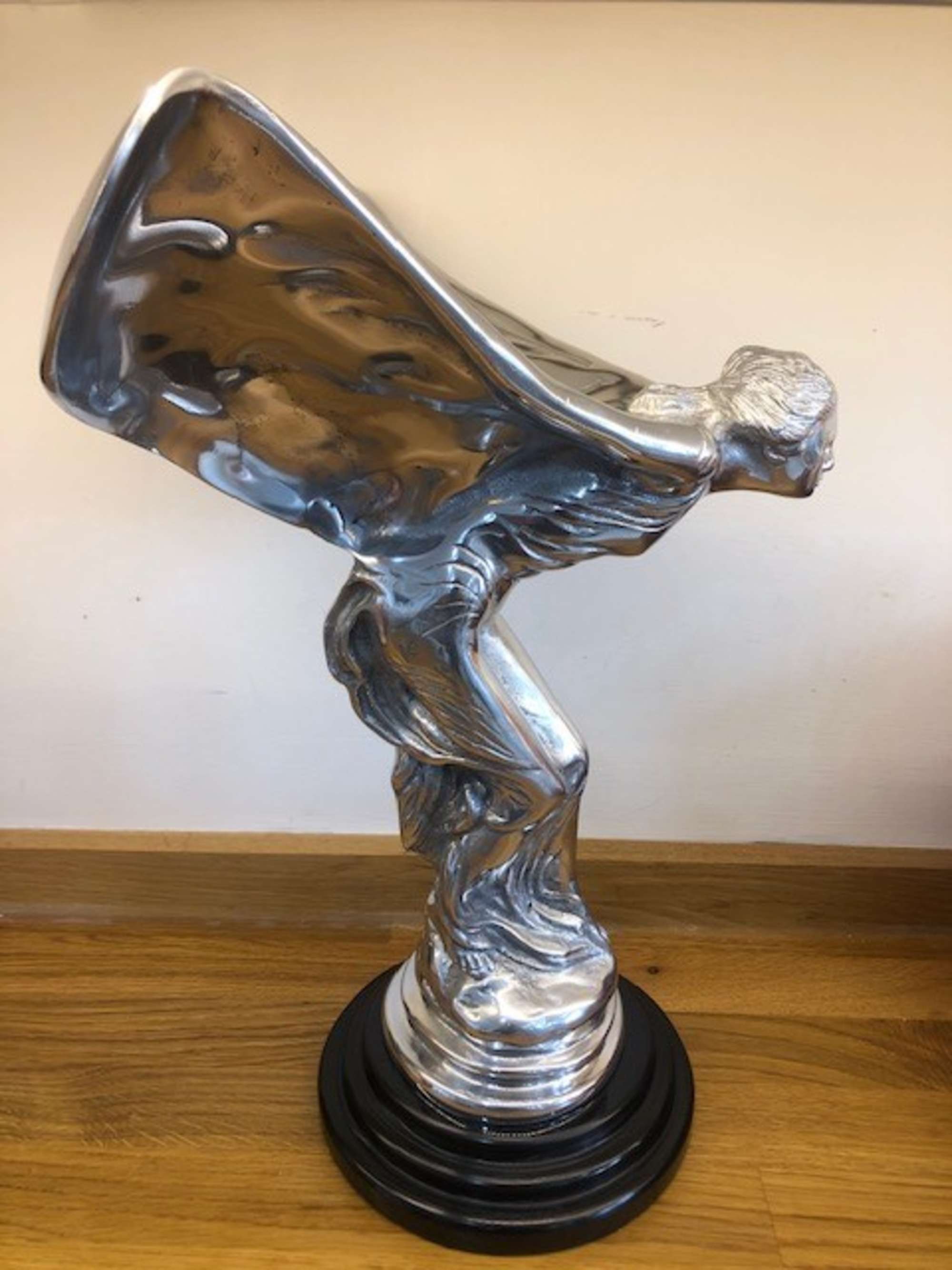 An over-sized cast metal and silvered statue of the Spirit o-Sold